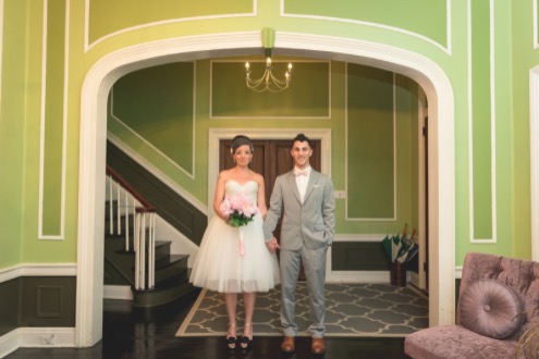 bride and groom posing inside old town manor