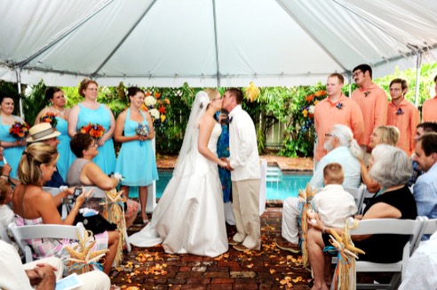 bride and groom kissing during wedding ceremony at old town manor